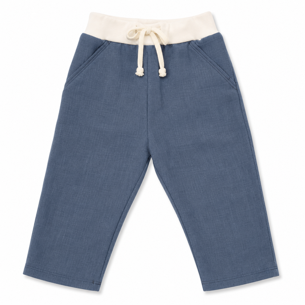 A pair of children's blue pants with an off-white elastic waistband and matching drawstring, shown flat on a white background.