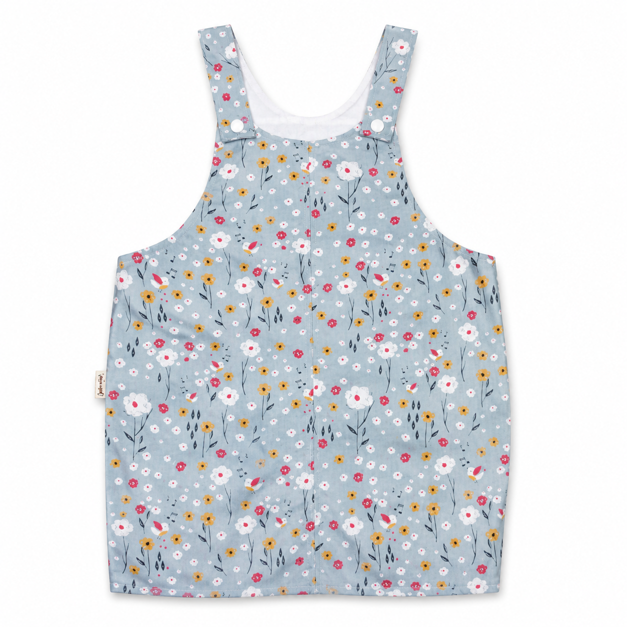 A sleeveless baby tank top with a light blue-gray background and a dense, colorful daisy floral print, featuring adjustable shoulder straps with snap buttons and a white inner neck lining.