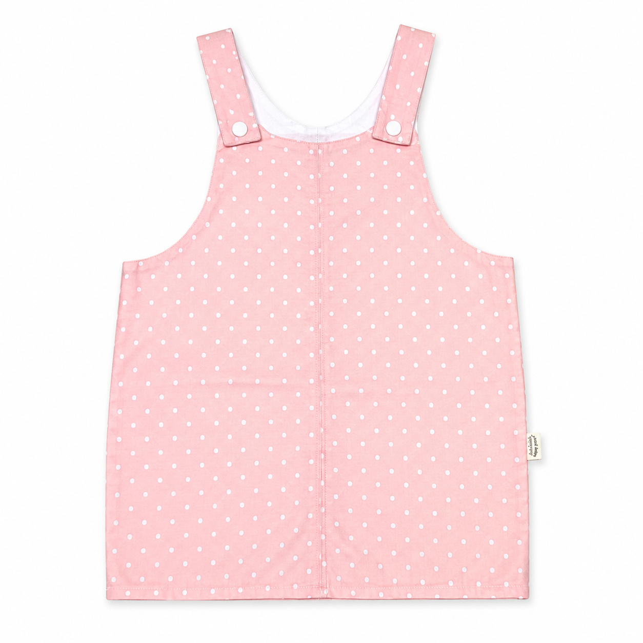 A pink sleeveless baby romper or overall-style top with white polka dots, featuring adjustable shoulder straps with snap buttons, shown flat against a white background.