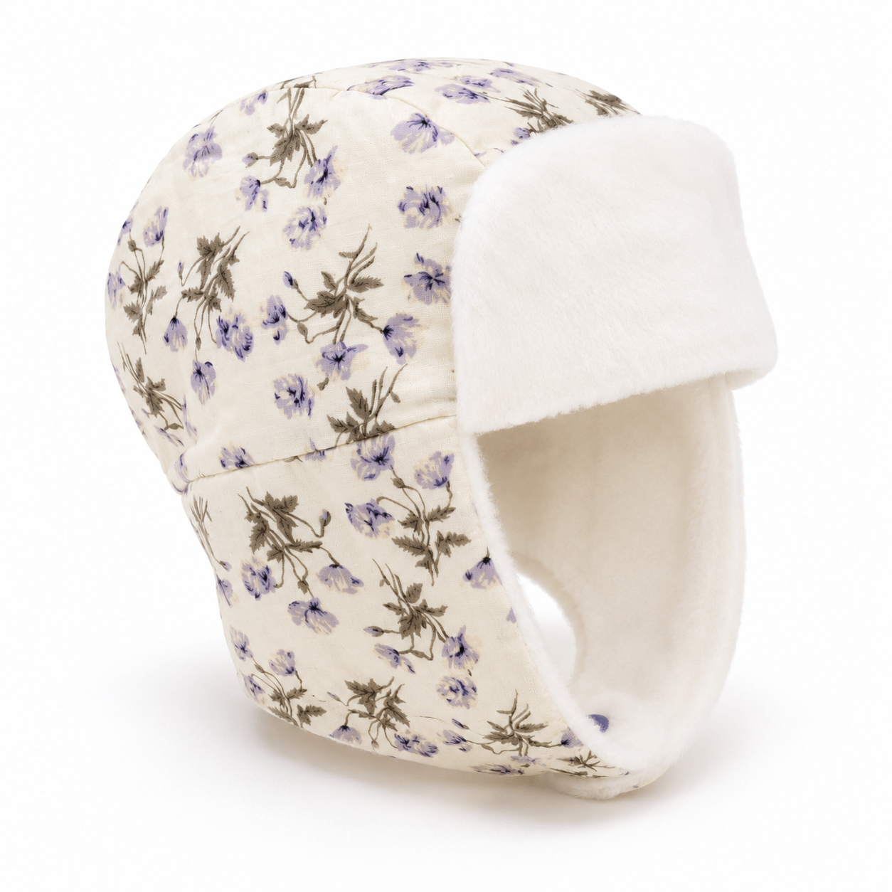 A quilted trapper hat featuring a cream-colored fabric body with a delicate purple and green floral pattern, and a soft white fleece lining.