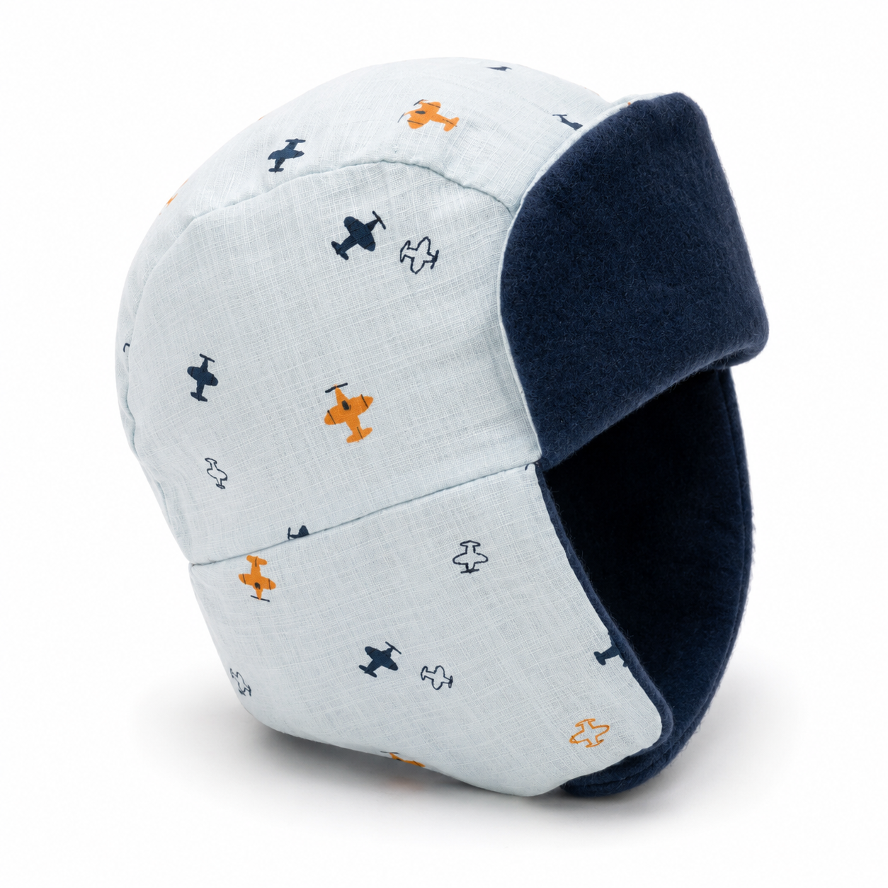A light blue baby trapper hat with a navy blue fleece ear flap and a pattern of small navy and orange airplanes, shown on a white background.