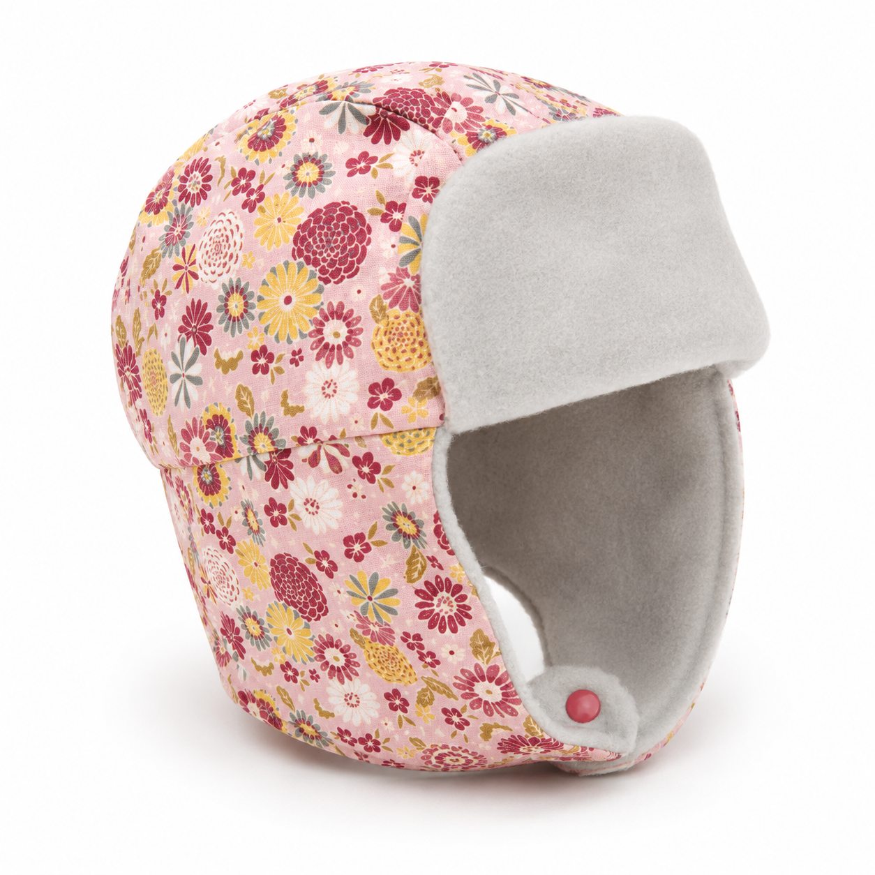 A pink floral trapper hat with a light gray fleece ear flap and lining, shown on a clean white background.