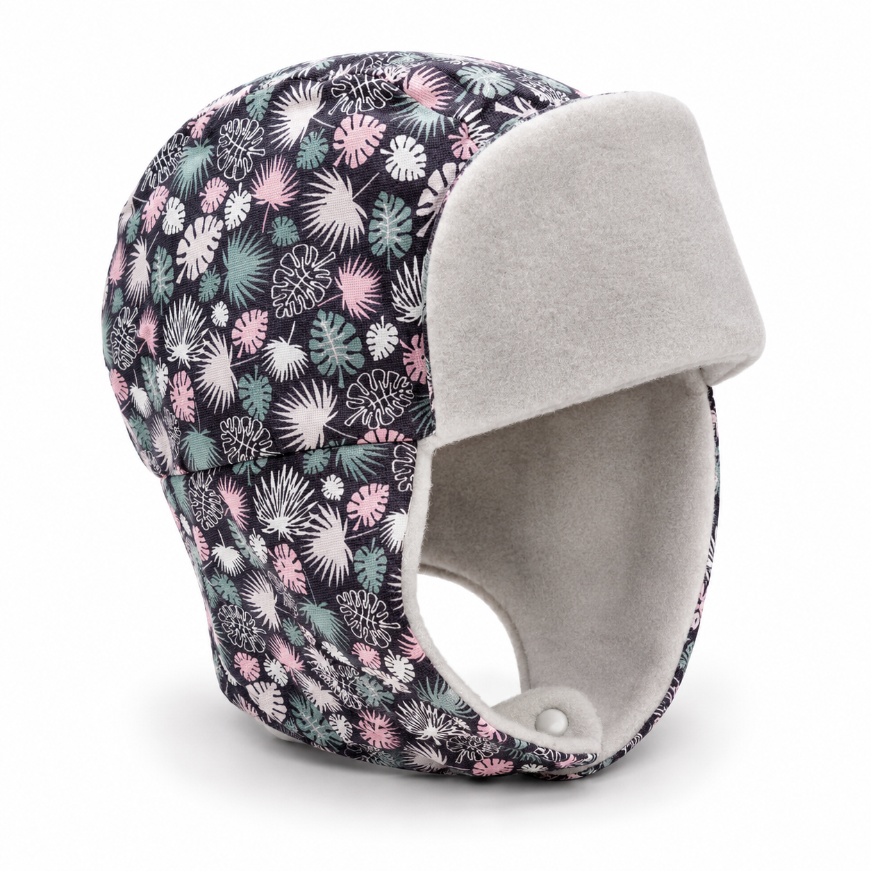A winter trapper hat featuring a dark navy blue base with a colorful floral and palm leaf pattern in pink, green, and white. The hat is lined with soft, light gray fleece on the ear flaps and inner lining, and is shown on a clean white background.