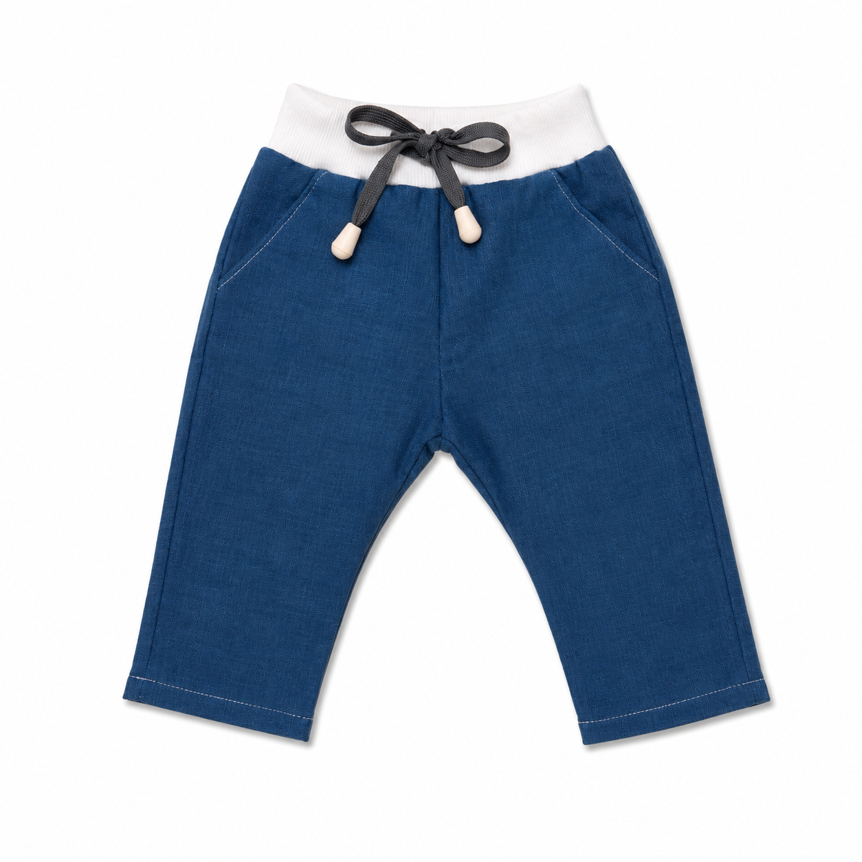 A pair of toddler blue denim pants with a white elastic waistband, a dark gray drawstring, and cream-colored toggle tips, shown against a plain white background.