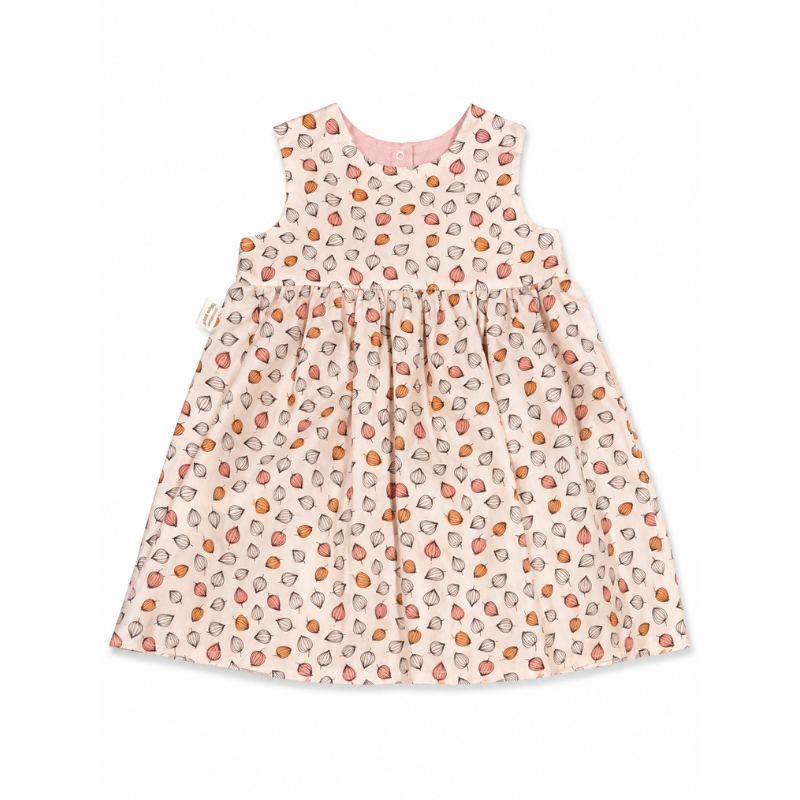 A sleeveless baby dress with a gathered waist, featuring an all-over print of small orange, pink, and gray watercolor shapes on a light pink background.