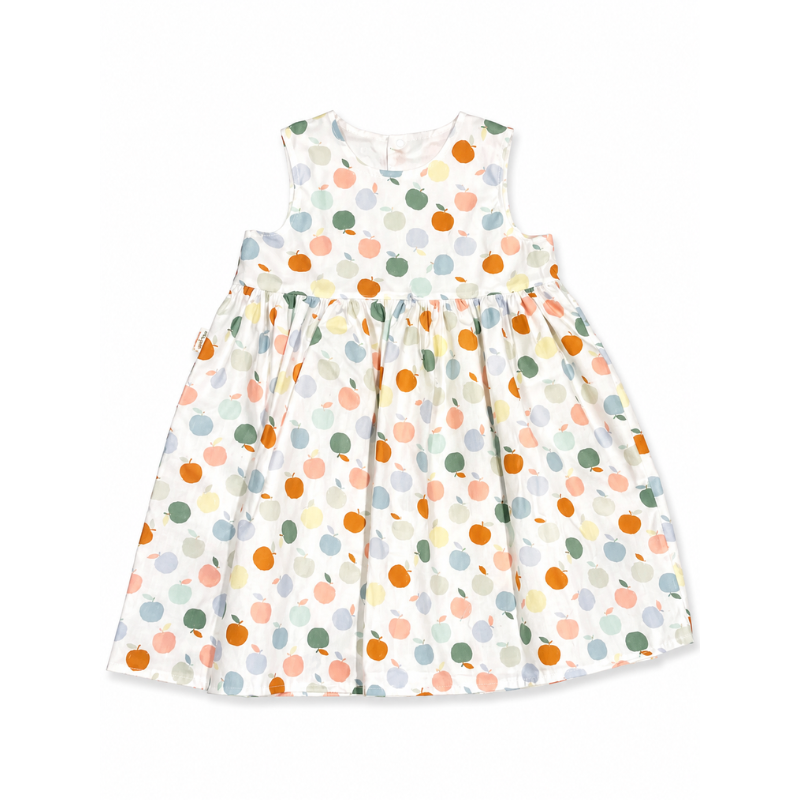 A sleeveless white baby dress with a colorful polka dot pattern, featuring orange, green, pink, and yellow dots, laid flat on a white background.