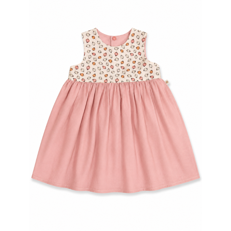 A sleeveless baby girl's dress with a pink pleated skirt and a cream bodice covered in a small multicolor floral and heart pattern, shown on a plain white background.