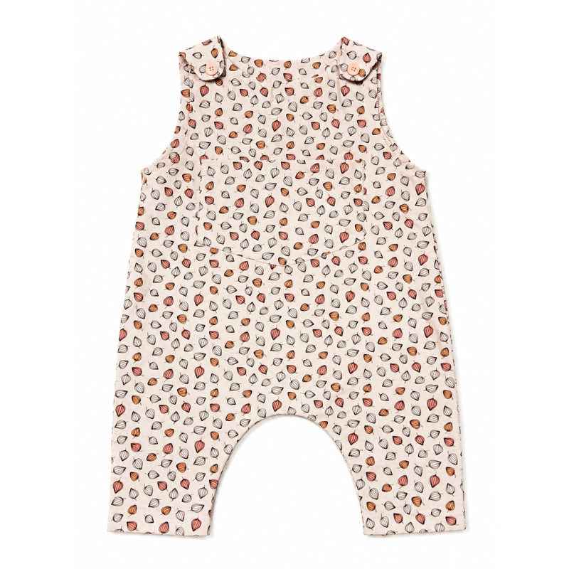 A sleeveless baby romper with an allover strawberry print on a cream background, featuring shoulder ruffles and leg openings, shown flat against a white background.